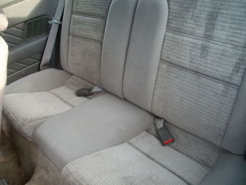 1989 Ford Probe - Interior view of the rear seats of a car, showing the upholstery and seatbelts.