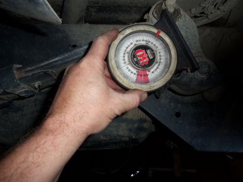1989 Ford Bronco - Using an angle gauge to measure suspension component alignment.
