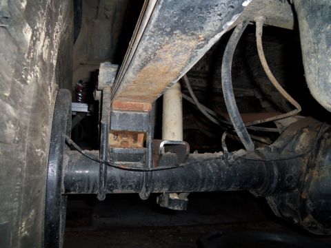 1989 Ford Bronco - This image shows the rear suspension and axle assembly of a vehicle, focusing on the leaf springs and shock absorber.