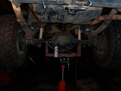1989 Ford Bronco - Underside view of a vehicle's rear axle and suspension system, showing leaf springs and shock absorbers.