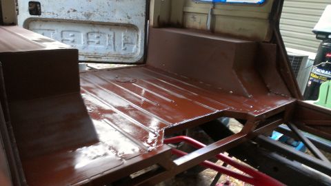 1978 Ford Bronco - The interior of a vehicle is shown with the floor and rear section painted brown, indicating ongoing restoration work.