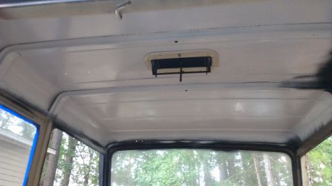 1978 Ford Bronco - The interior roof of a vehicle, showing a vent and a watermark from Supermotors.net.