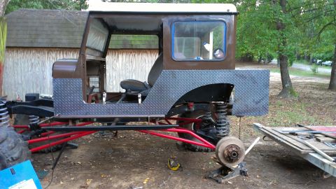 1978 Ford Bronco - This custom off-road vehicle appears to be undergoing significant modifications, with its chassis and suspension prominently displayed.