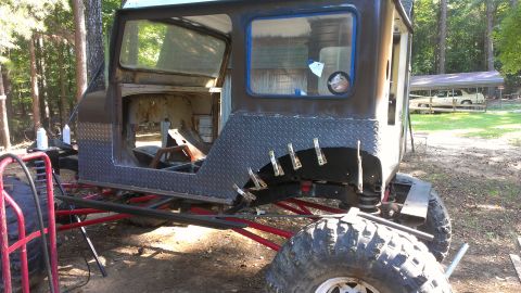 1978 Ford Bronco - This heavily modified vehicle, possibly a custom build, is seen in a state of construction with its doors and roof removed.