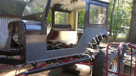 1978 Ford Bronco - Custom off-road vehicle body being modified with diamond plate panels and exposed frame.