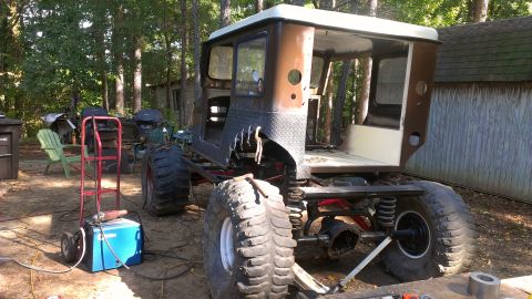 1978 Ford Bronco - This heavily modified vehicle is in a yard with a welding machine nearby, suggesting ongoing work.