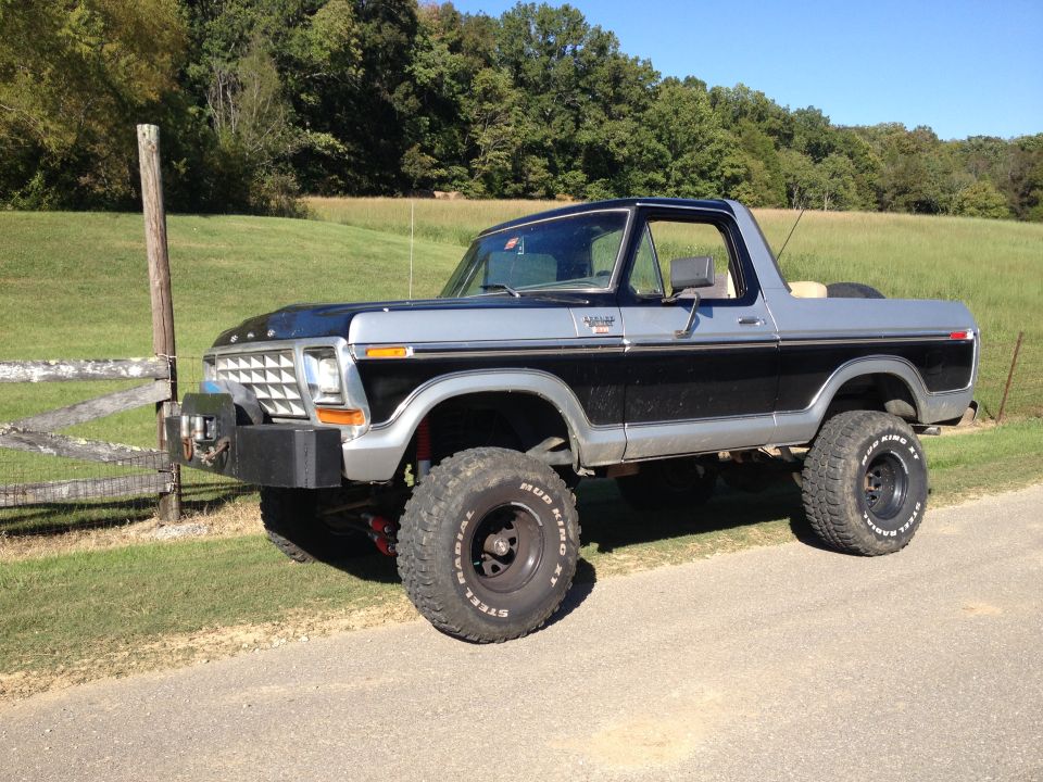 Black and silver lifted 1979 Ford Bronco with off-road tires