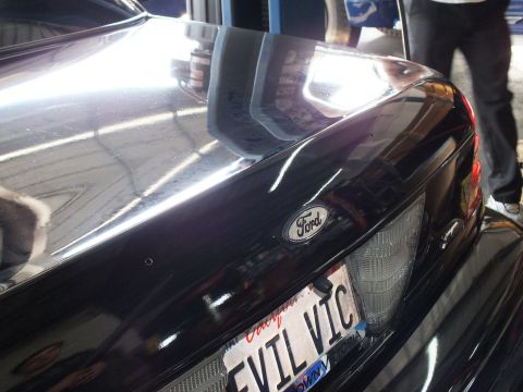 2003 Ford Crown Victoria - Close angle of a black Ford rear deck, Ford emblem above an EVIL VIC license plate.