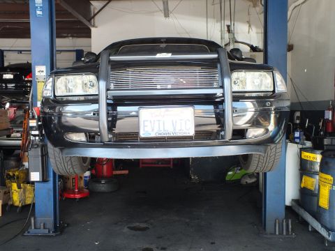 2003 Ford Crown Victoria - Close front view of a Crown Victoria on a lift with EVIL VIC plate and billet grille insert