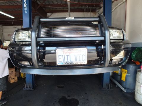 2003 Ford Crown Victoria - Front bumper and tubular brush guard of a lifted Crown Victoria with EVIL VIC plate