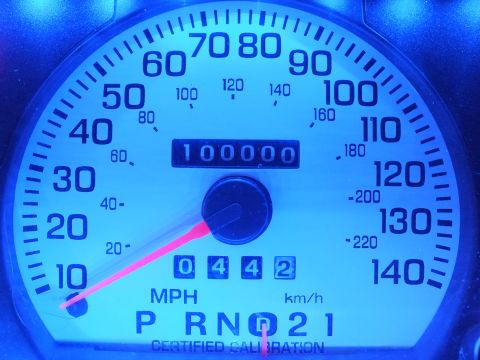 2003 Ford Crown Victoria - Blue-lit gauge cluster showing odometer at 100000 miles with PRND21 gear indicator