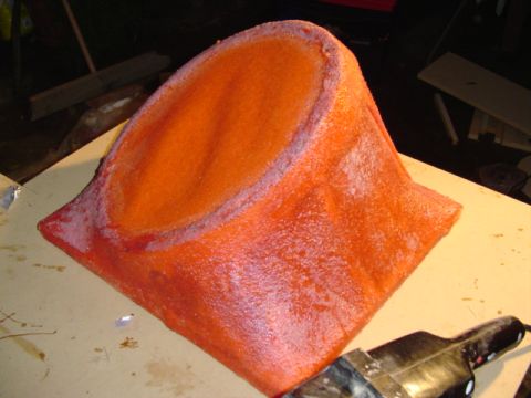 1999 Ford Taurus - Custom fiberglass part with an orange textured finish is shown on a workbench.