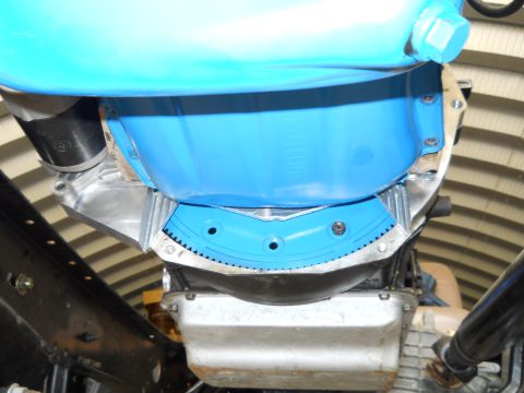 1992 Ford Bronco - Underside view of a vehicle's transmission bell housing, a bright blue protective cover.