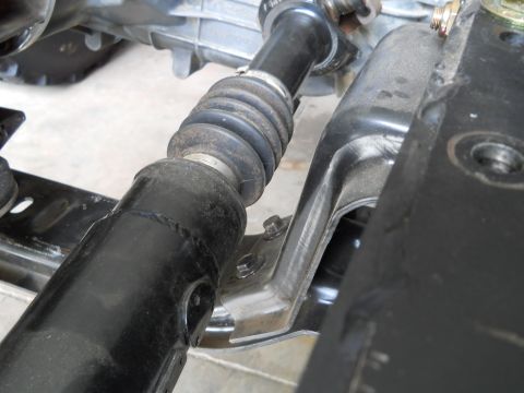 1992 Ford Bronco - Close-up view of the driveshaft and suspension components of a vehicle.