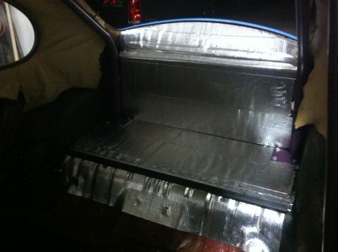 1970 Volkswagen Beetle - Sound deadening material is installed on the floor and rear panel of a car's interior.