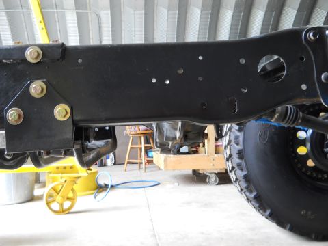 1992 Ford Bronco - Vehicle frame and tire detail, likely during maintenance or restoration.