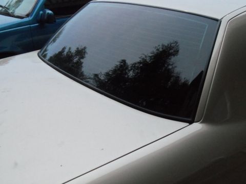2000 Mercury Grand Marquis - Rear view of a car, with another vehicle parked nearby.