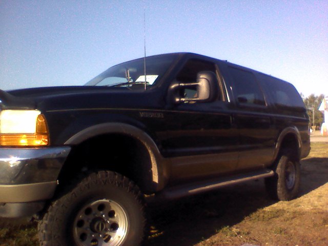 Black 2000 Ford Excursion SUV, three-quarter front view, parked outdoors