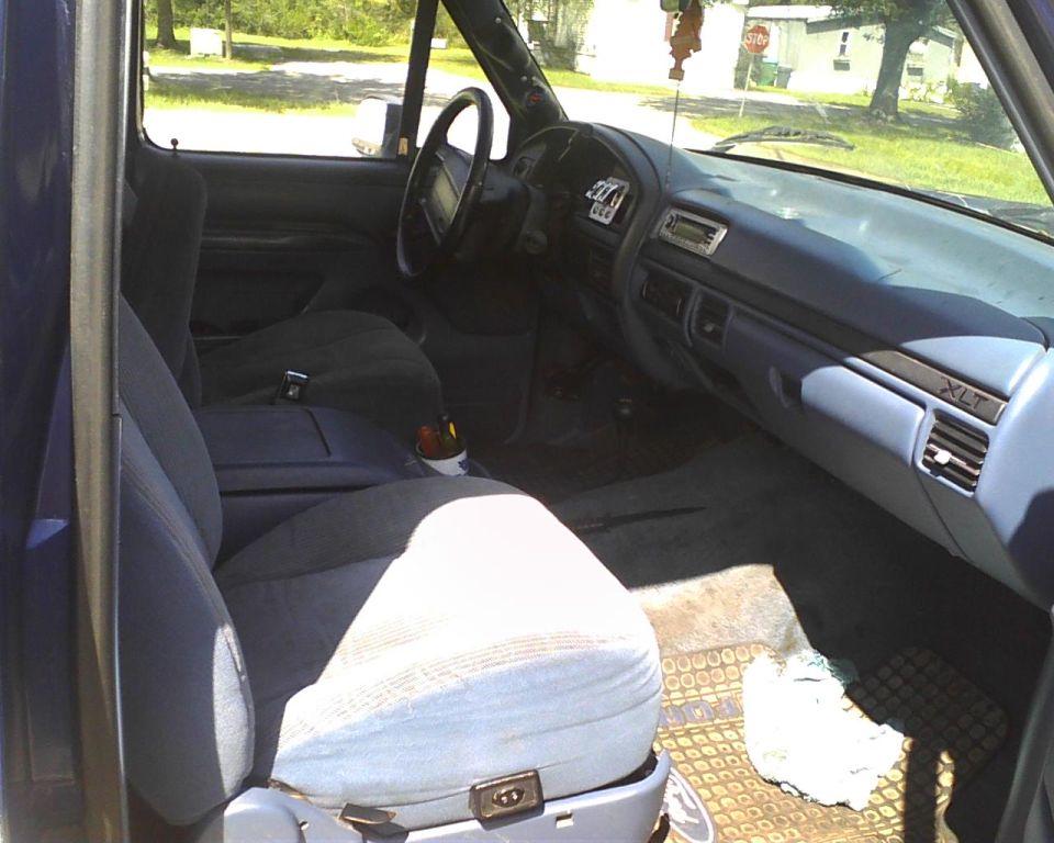 1996 Ford Bronco interior showing front seats, dashboard, and steering wheel