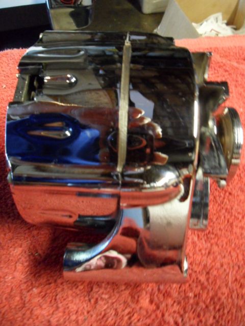 1994 Jeep Cherokee - A chrome-plated automotive part is shown from the side, resting on a red textured surface.