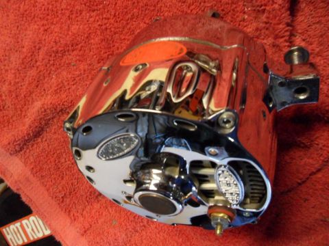 1994 Jeep Cherokee - This chrome-plated part, possibly an alternator or similar component, is shown on a red textured surface.