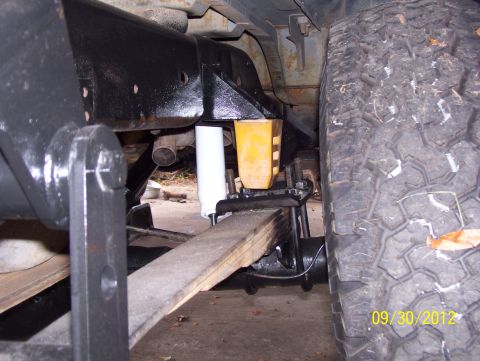 1990 Ford Bronco - Close-up view of the rear suspension components, including leaf springs and shock absorbers, on a vehicle.