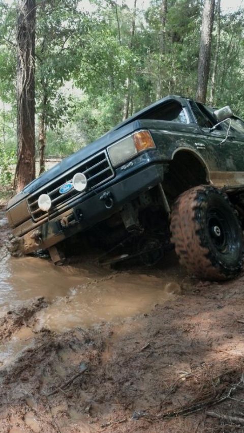 1990 Ford Bronco - This 1990 Ford Bronco is stuck deep in the mud on a wooded trail.