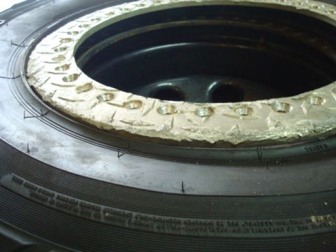 1995 Ford Bronco - A tire and its beadlock wheel are shown in detail, highlighting the bolted metal ring around the rim.