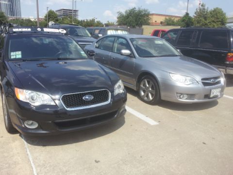 2008 Subaru Legacy - Two Subaru Legacy models are parked side-by-side in a lot under a clear sky.