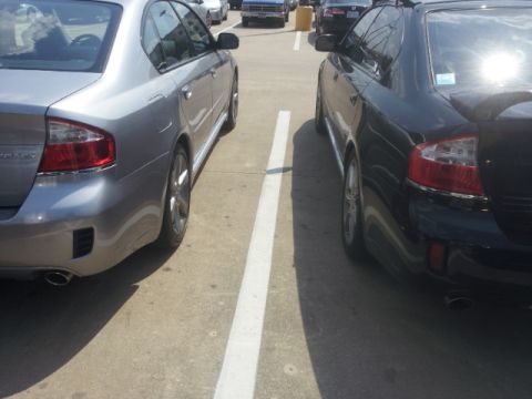 2008 Subaru Legacy - Two Subaru Legacy sedans are parked next to each other in a parking lot.