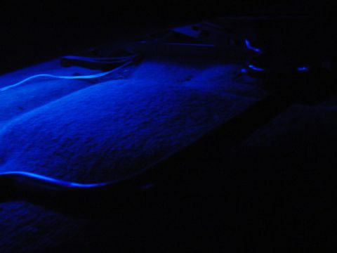 1999 Ford Taurus - Blue underglow lighting illuminates the carpeted floor of a car interior.