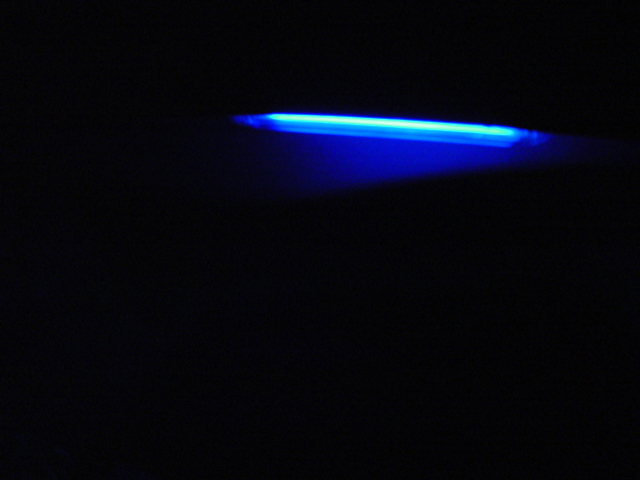 Blue light strip on black background