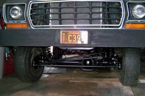 1978 Ford Bronco - The front grille and headlights of a 1978 Ford Bronco are visible, along with its suspension system.