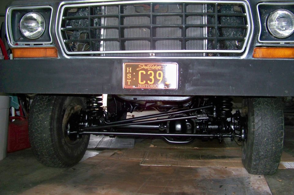Front view of a 1978 Ford Bronco showing grille, headlights, bumper, and suspension components