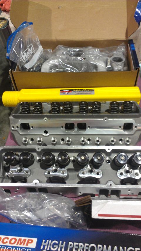 1973 Chevrolet Camaro - Close-up view of engine cylinder heads, valve springs, and a yellow tool, with packaging visible.