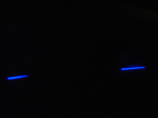 Two blue light strips on a black background, with SUPERMOTORS text at the bottom right