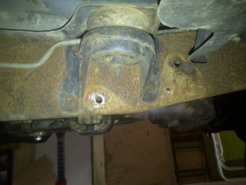 1995 Ford Bronco - Body mount before removing rivets and bolting hanger over top of it