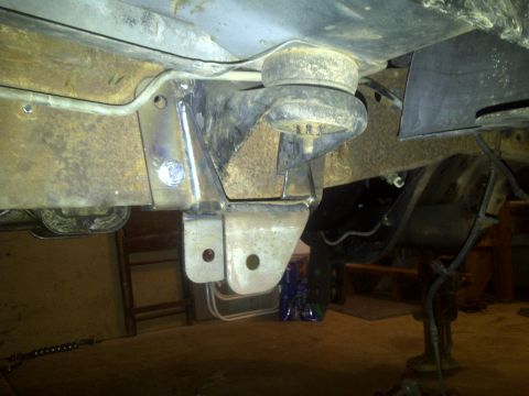 1995 Ford Bronco - The photo shows a close-up view of the vehicle's frame and suspension system, likely during a repair or modification.