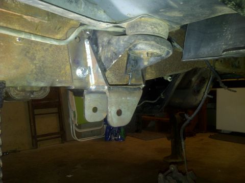 1995 Ford Bronco - Close-up of the undercarriage of a 1995 Ford Bronco, showing suspension components and frame modifications.