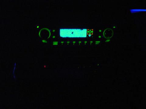 1999 Ford Taurus - The car's stereo system is illuminated with a bright green display and matching buttons.