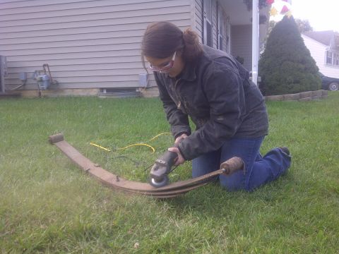 1995 Ford Bronco - Leaf spring being worked on outdoors.