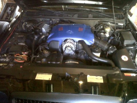 1999 Ford Crown Victoria - Engine bay of a 1999 Ford Crown Victoria, showing the engine and various components under the hood.