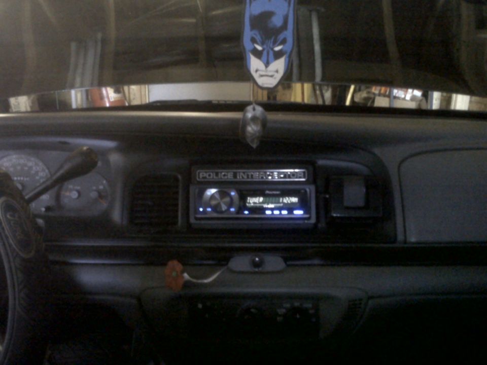 1999 Ford Crown Victoria interior dashboard with "POLICE INTERCEPTOR" badge above a Pioneer stereo