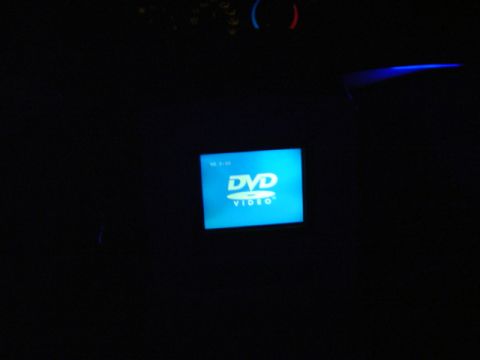 1999 Ford Taurus - A car's interior at night, illuminated by a bright blue DVD Video screen and ambient lighting.