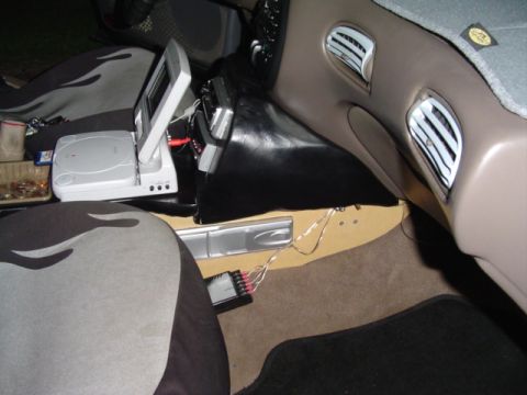 1999 Ford Taurus - Custom car interior features a screen, game console, and amplifier, with visible wiring.
