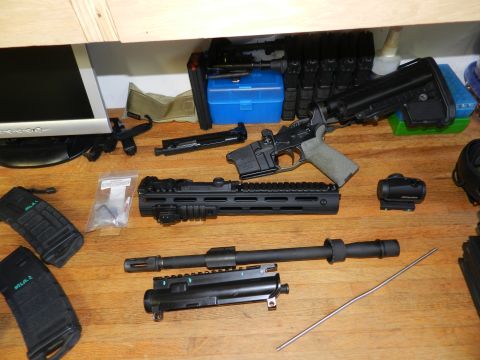 1996 Ford Bronco - Various components of a firearm are arranged on a table, ready for assembly or maintenance.