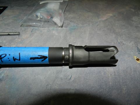 1996 Ford Bronco - A close-up view of a gun muzzle brake with markings and tape.