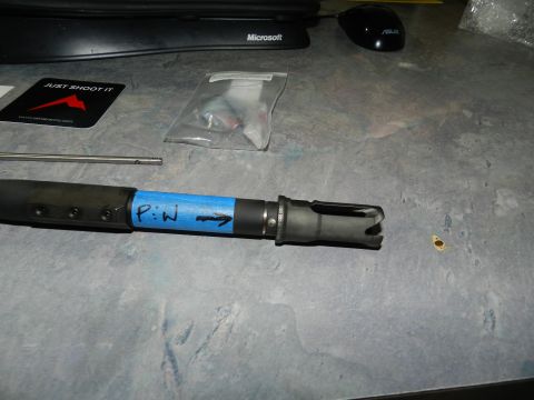 1996 Ford Bronco - A gun barrel with a muzzle brake is shown, marked with blue tape indicating "P:W" and an arrow.