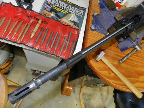 1996 Ford Bronco - A gun barrel is secured in a vise, with reloading tools nearby.