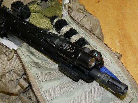 1996 Ford Bronco - A tactical rifle with a mounted flashlight and optic is placed inside a bag.